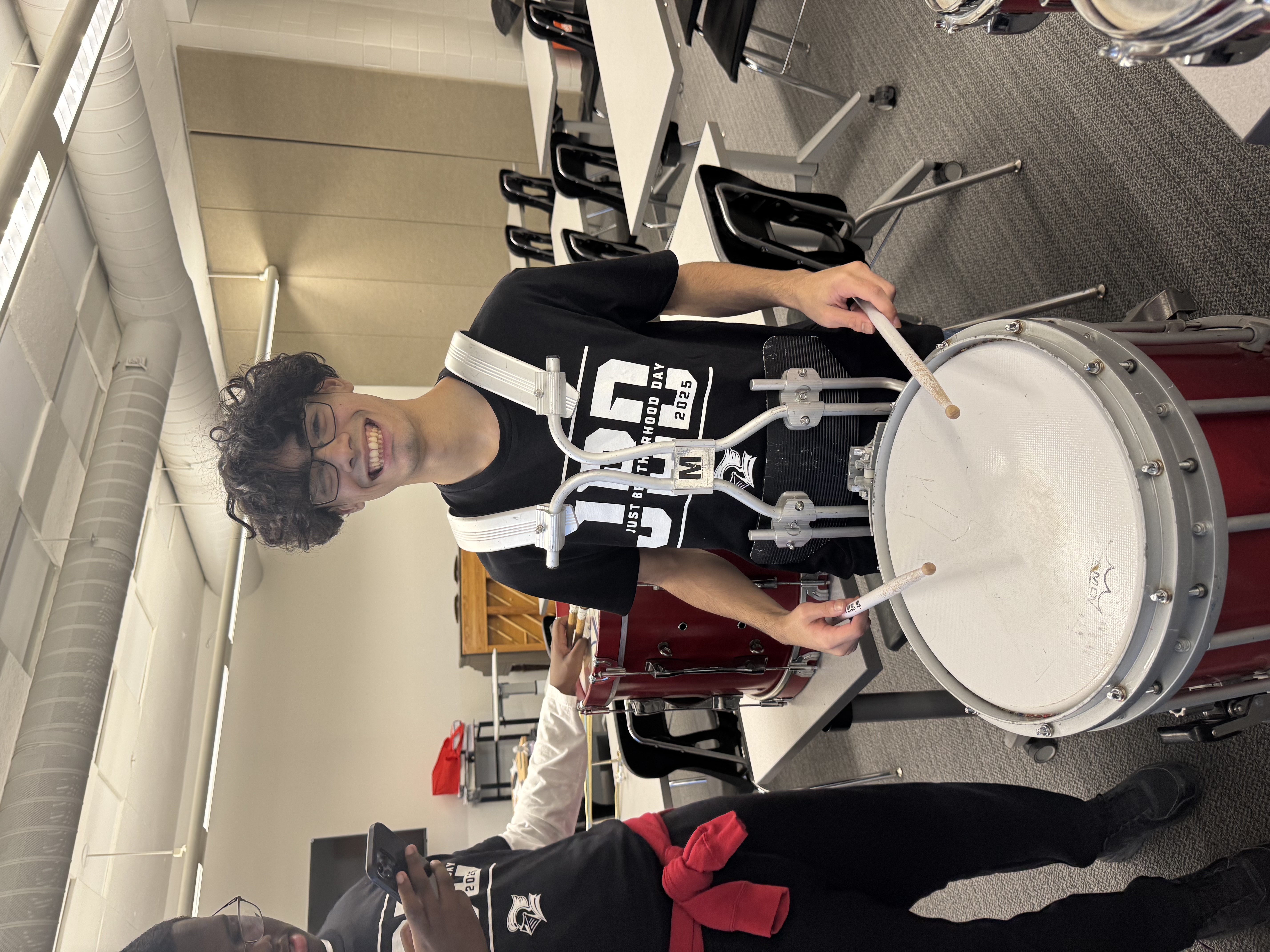 Jon Ortiz, one of the band members who didn't play their instrument when they joined, holding it.