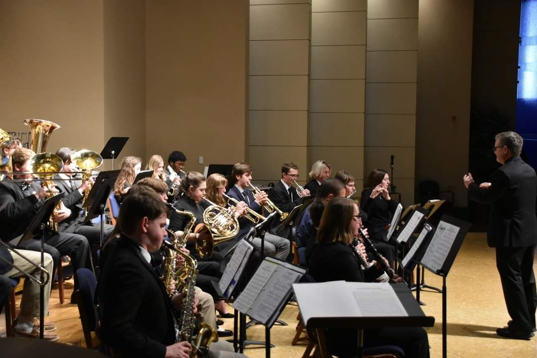 COncert band members playing at a concert.